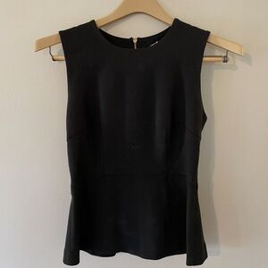 Club Monaco. scoop neck black peplum top with zip closure in back. Size Small.